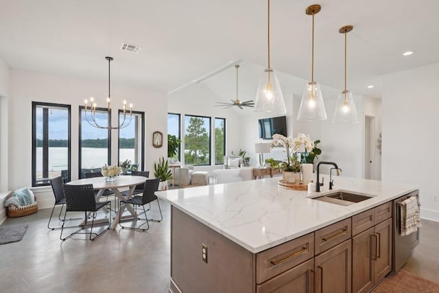 52554 Shore Dr, Franklinton, LA 70438 - kitchen featuring light stone countertops, hanging light fixtures, a chandelier, recessed lighting, and finished concrete floors