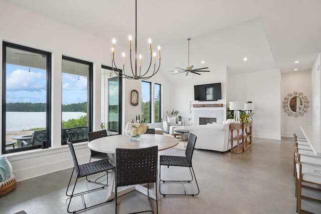 52554 Shore Dr, Franklinton, LA 70438 - dining space featuring concrete flooring, a fireplace, recessed lighting, a chandelier, and a water view