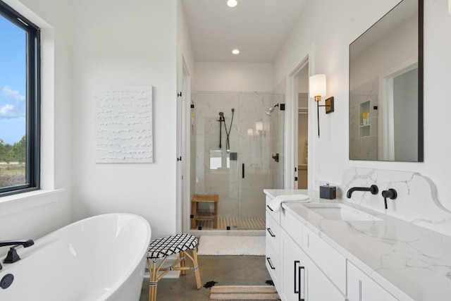 52554 Shore Dr, Franklinton, LA 70438 - full bathroom with healthy amount of natural light, a shower stall, vanity, a soaking tub, and recessed lighting