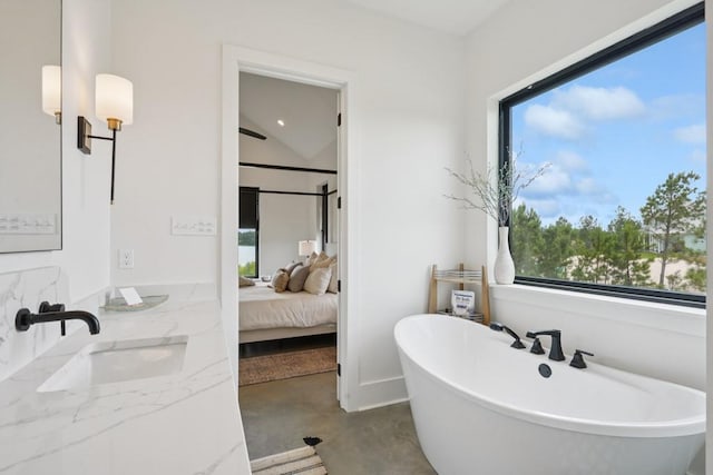 52554 Shore Dr, Franklinton, LA 70438 - ensuite bathroom featuring a freestanding bath, finished concrete floors, and double vanity