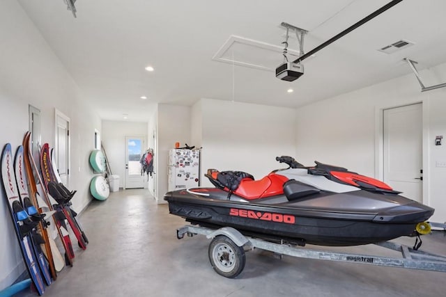 52554 Shore Dr, Franklinton, LA 70438 - garage featuring a garage door opener and recessed lighting