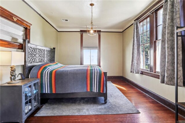 1919 Robert St, New Orleans, LA 70115 - bedroom with dark wood-type flooring and crown molding