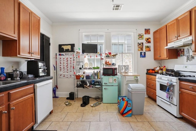 432426 Banks St, New Orleans, LA 70119 - kitchen featuring white appliances, under cabinet range hood, dark countertops, ornamental molding, and light tile patterned flooring