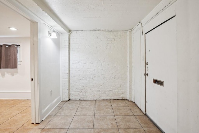 432426 Banks St, New Orleans, LA 70119 - hall featuring light tile patterned flooring and brick wall