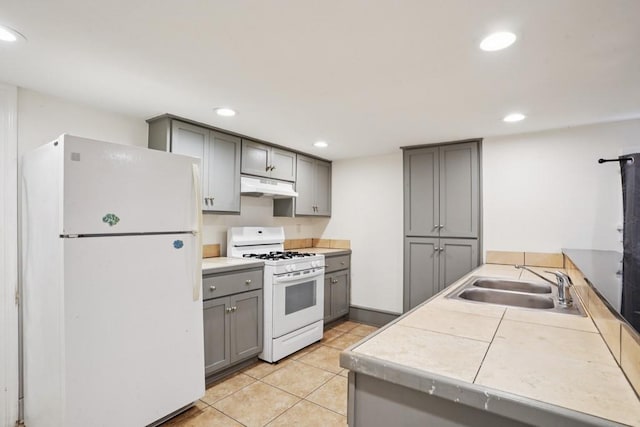 432426 Banks St, New Orleans, LA 70119 - kitchen with white appliances, gray cabinets, under cabinet range hood, recessed lighting, and light tile patterned floors
