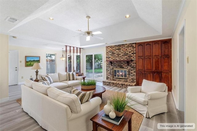 4013 Taft Park, Metairie, LA 70002 - living area featuring a tray ceiling, a textured ceiling, ceiling fan, light wood-style floors, and a fireplace