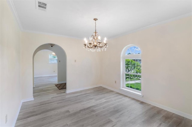 4013 Taft Park, Metairie, LA 70002 - unfurnished room featuring arched walkways, a chandelier, light wood-style flooring, and ornamental molding