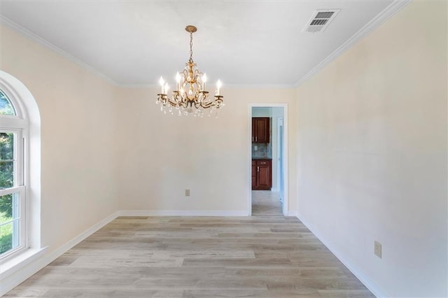 4013 Taft Park, Metairie, LA 70002 - spare room with a chandelier, healthy amount of natural light, crown molding, light wood-style flooring, and arched walkways