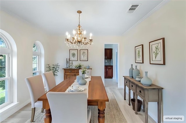 4013 Taft Park, Metairie, LA 70002 - dining area featuring a chandelier, light wood-style flooring, and ornamental molding