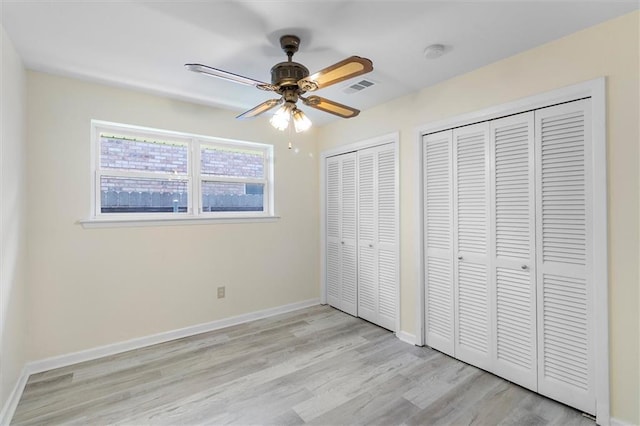 4013 Taft Park, Metairie, LA 70002 - unfurnished bedroom with multiple closets, light wood-type flooring, and ceiling fan