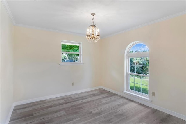 4013 Taft Park, Metairie, LA 70002 - empty room featuring healthy amount of natural light, a chandelier, wood finished floors, and ornamental molding