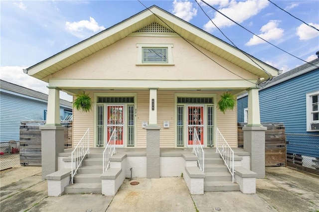 62426 9th St, New Orleans, LA 70115 - view of front facade featuring covered porch and stucco siding