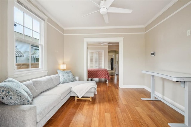 62426 9th St, New Orleans, LA 70115 - living room featuring a ceiling fan, light wood-style floors, ornamental molding, and arched walkways