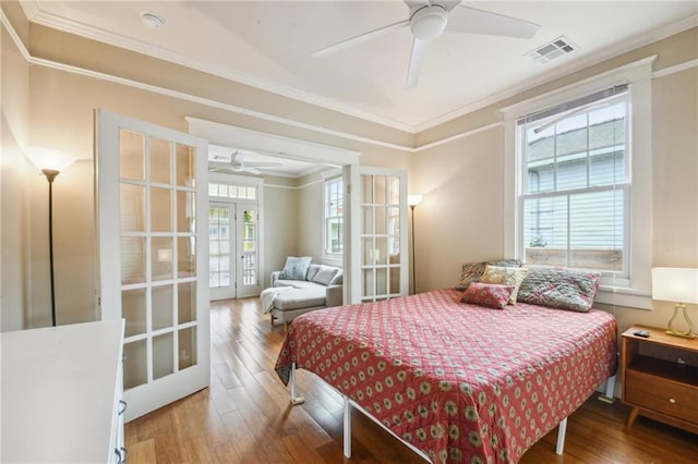 62426 9th St, New Orleans, LA 70115 - bedroom with wood finished floors, french doors, crown molding, and ceiling fan