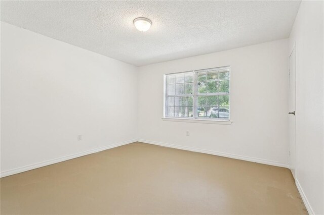 601 Jw Davis Dr, Hammond, LA 70403 - carpeted empty room featuring a textured ceiling and baseboards