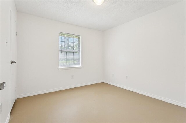 601 Jw Davis Dr, Hammond, LA 70403 - carpeted spare room with a textured ceiling and baseboards