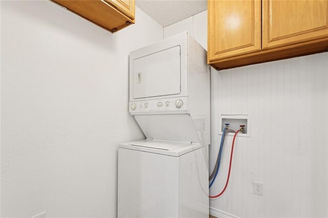 601 Jw Davis Dr, Hammond, LA 70403 - laundry area with cabinet space and stacked washing machine and dryer