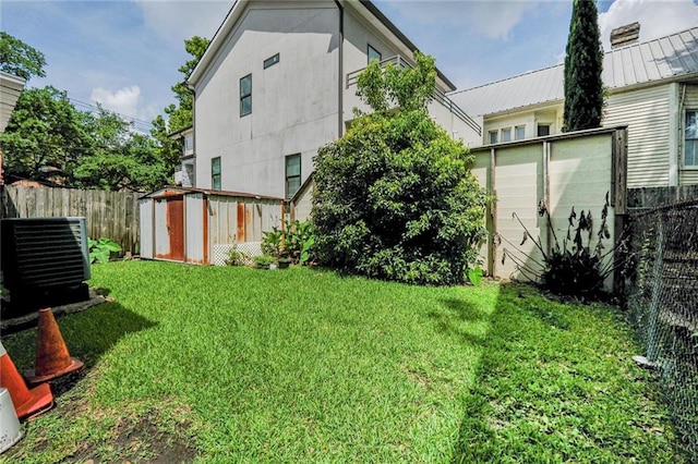 2727 Carondelet St, New Orleans, LA 70130 - rear view of house with a storage shed and a fenced backyard