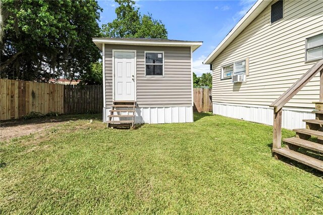 564 Mathew St, Lafitte, LA 70067 - view of outbuilding with entry steps, a fenced backyard, and cooling unit