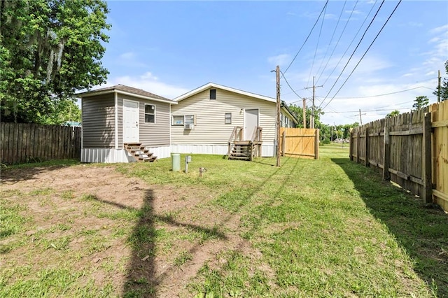 564 Mathew St, Lafitte, LA 70067 - rear view of house featuring entry steps and a fenced backyard