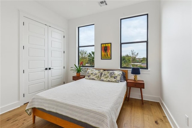 810 N Roman St, New Orleans, LA 70116 - bedroom featuring light wood finished floors and a closet
