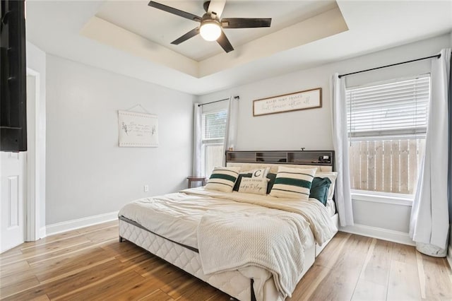2311 Jay St, Slidell, LA 70460 - bedroom featuring a raised ceiling, hardwood / wood-style flooring, and a ceiling fan