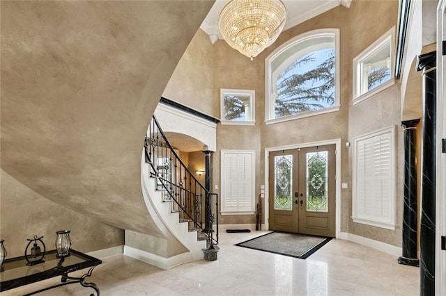 154 Primrose Dr, Belle Chasse, LA 70037 - entryway with plenty of natural light, french doors, stairway, a chandelier, and a high ceiling