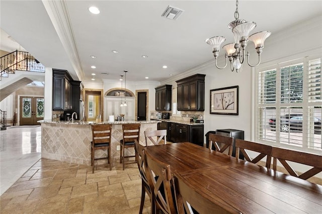 154 Primrose Dr, Belle Chasse, LA 70037 - dining space with ornamental molding, a chandelier, stone tile floors, recessed lighting, and stairs