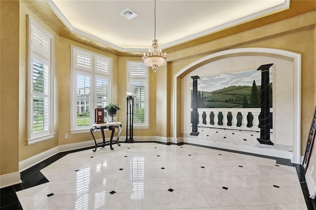 154 Primrose Dr, Belle Chasse, LA 70037 - entrance foyer with a chandelier, inlaid floor details, plenty of natural light, crown molding, and a tray ceiling