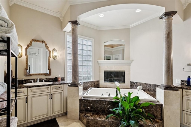 154 Primrose Dr, Belle Chasse, LA 70037 - full bath with decorative columns, vanity, a bath, ornamental molding, and a tiled fireplace