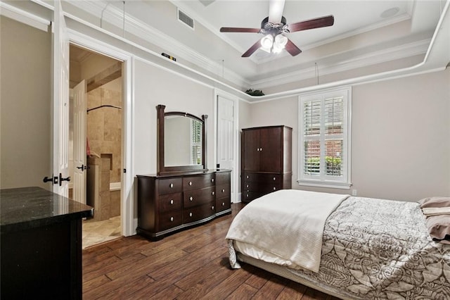 154 Primrose Dr, Belle Chasse, LA 70037 - bedroom featuring dark wood-style floors, crown molding, a raised ceiling, a ceiling fan, and ensuite bathroom
