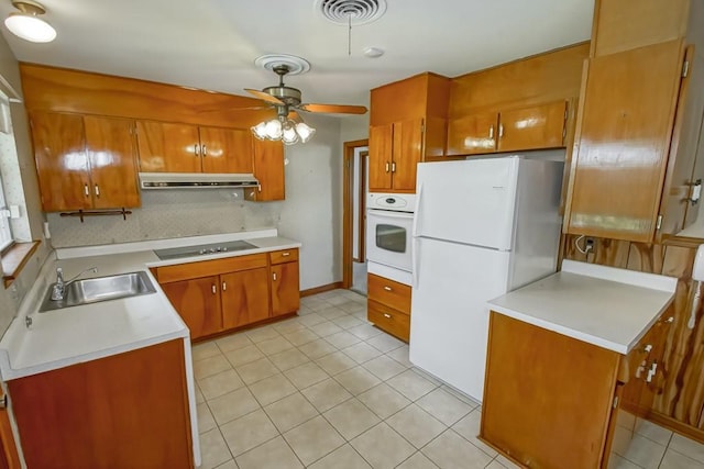 4213 Purdue Dr, Metairie, LA 70003 - kitchen featuring white appliances, under cabinet range hood, brown cabinets, and a ceiling fan