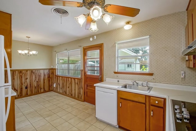 4213 Purdue Dr, Metairie, LA 70003 - kitchen featuring white appliances, ceiling fan, wainscoting, light countertops, and a chandelier