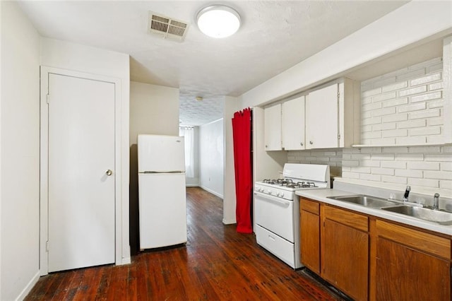 523-25 Spain St, New Orleans, LA 70117 - kitchen with white appliances, light countertops, and dark wood-style floors