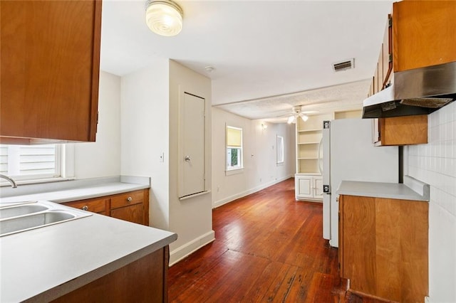 523-25 Spain St, New Orleans, LA 70117 - kitchen with dark wood-style floors, a ceiling fan, brown cabinetry, and light countertops