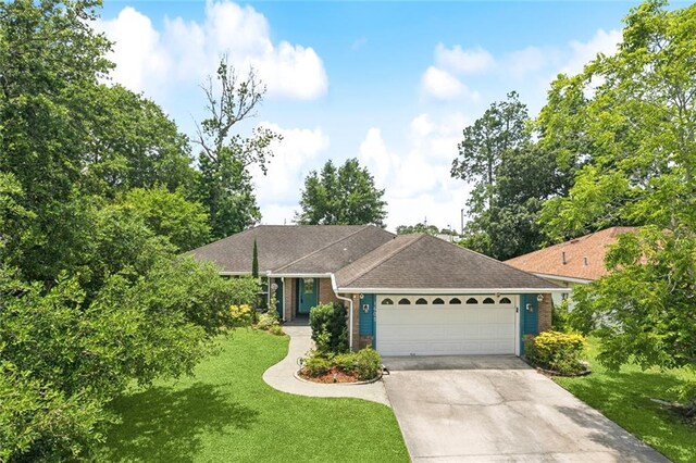 1605 Rue Lemans, Slidell, LA 70458 - single story home featuring an attached garage, concrete driveway, a front lawn, and brick siding