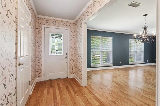 1605 Rue Lemans, Slidell, LA 70458 - entryway with a chandelier, crown molding, light wood finished floors, and wallpapered walls