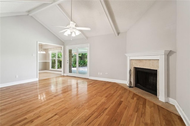 1605 Rue Lemans, Slidell, LA 70458 - unfurnished living room featuring wood finished floors, a ceiling fan, a tiled fireplace, and a textured ceiling