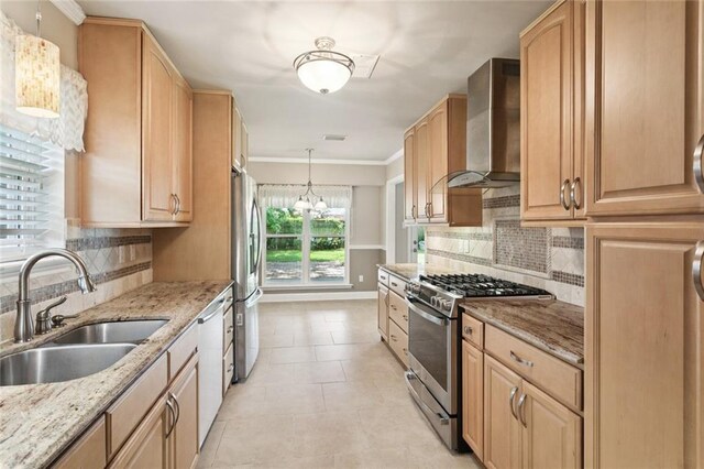 1605 Rue Lemans, Slidell, LA 70458 - kitchen with appliances with stainless steel finishes, wall chimney range hood, light brown cabinetry, tasteful backsplash, and ornamental molding