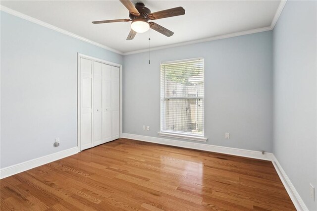 1605 Rue Lemans, Slidell, LA 70458 - unfurnished bedroom featuring wood finished floors, crown molding, a closet, and a ceiling fan