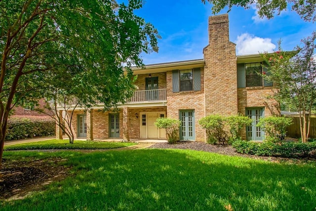 8808 Chretien Point Pl, River Ridge, LA 70123 - view of front of property with french doors, a balcony, brick siding, and a front yard