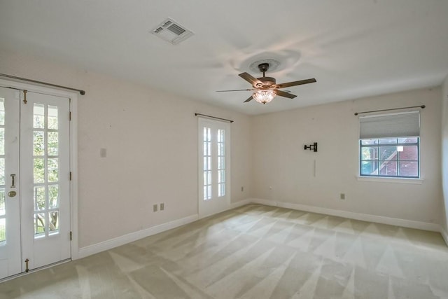 8808 Chretien Point Pl, River Ridge, LA 70123 - empty room with plenty of natural light, a ceiling fan, and light colored carpet