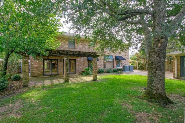 8808 Chretien Point Pl, River Ridge, LA 70123 - rear view of property with a yard and brick siding