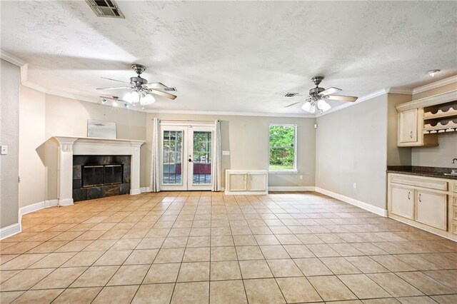 2142 Park Dr, Slidell, LA 70458 - unfurnished living room with a ceiling fan, crown molding, light tile patterned floors, french doors, and a textured ceiling