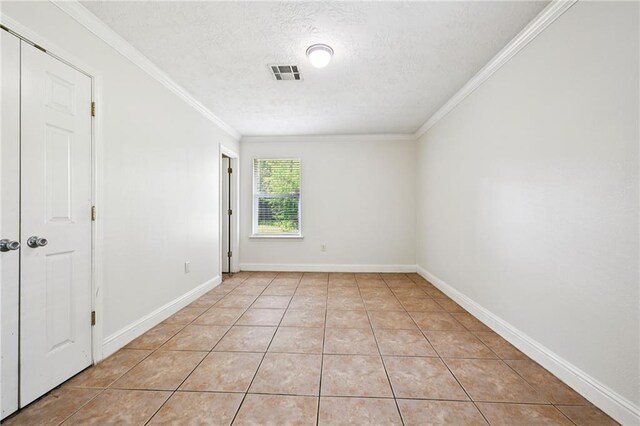 2142 Park Dr, Slidell, LA 70458 - unfurnished room with a textured ceiling, ornamental molding, and light tile patterned floors