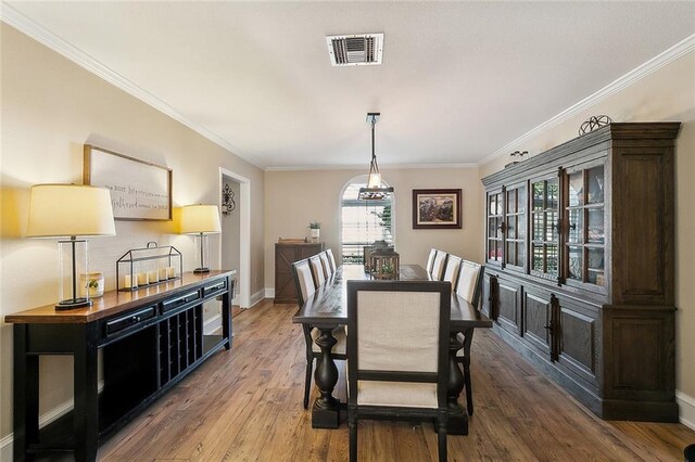 9408 Citrus Ln, River Ridge, LA 70123 - dining area featuring wood finished floors and ornamental molding