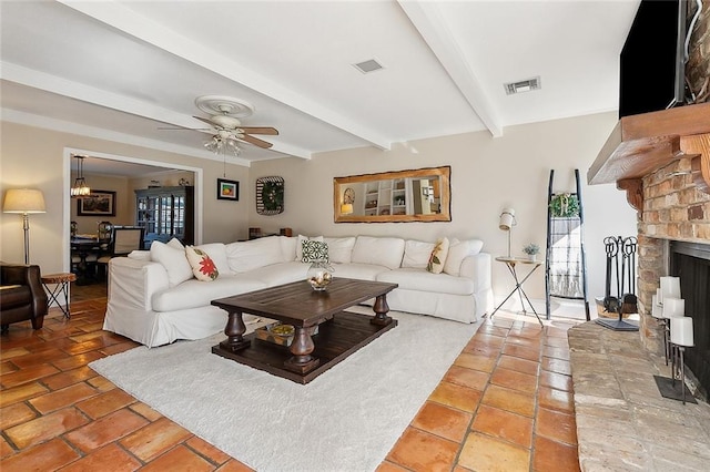 9408 Citrus Ln, River Ridge, LA 70123 - living room with a fireplace, beam ceiling, a ceiling fan, and light tile patterned floors