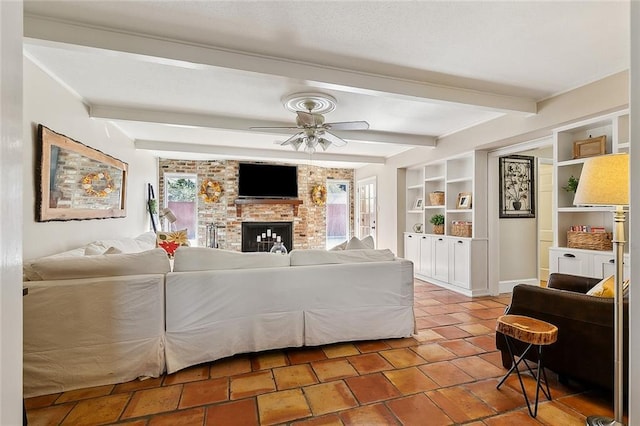 9408 Citrus Ln, River Ridge, LA 70123 - living room featuring healthy amount of natural light, a ceiling fan, beamed ceiling, and a brick fireplace