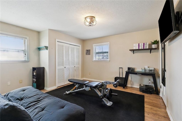 9408 Citrus Ln, River Ridge, LA 70123 - workout room with wood finished floors and a textured ceiling