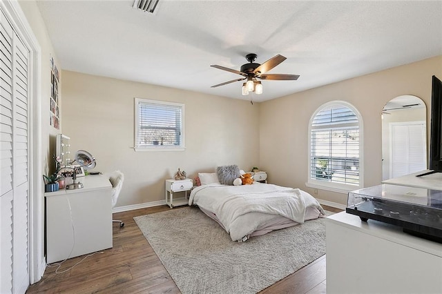 9408 Citrus Ln, River Ridge, LA 70123 - bedroom with multiple windows, wood finished floors, and a ceiling fan